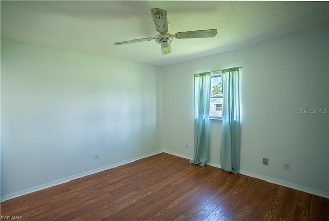 unfurnished room featuring ceiling fan and dark hardwood / wood-style flooring