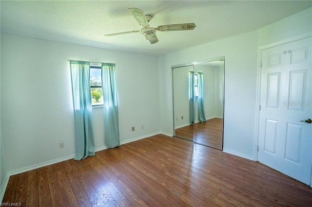 unfurnished bedroom with ceiling fan and dark hardwood / wood-style floors