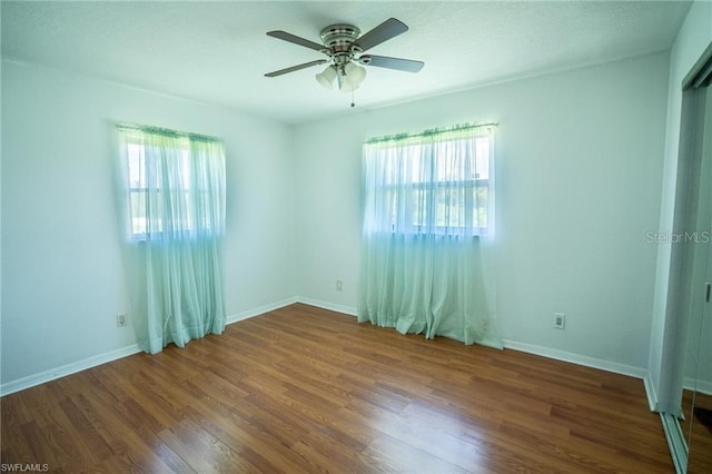 empty room with wood-type flooring and ceiling fan