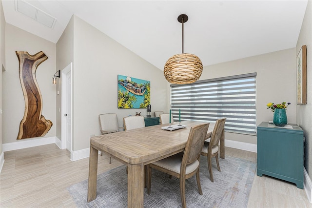 dining area featuring vaulted ceiling