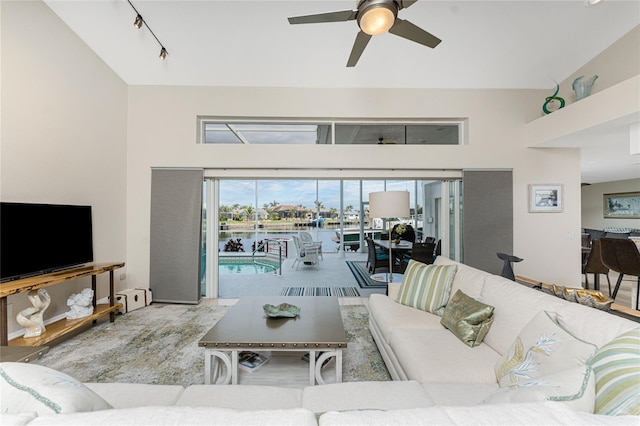 living room featuring rail lighting and ceiling fan