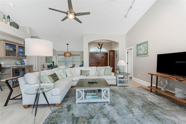 living room featuring wine cooler, rail lighting, and ceiling fan