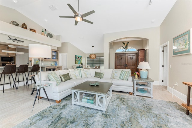 living room featuring vaulted ceiling and ceiling fan