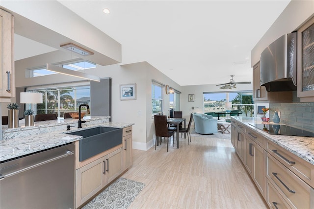 kitchen with dishwasher, sink, decorative backsplash, black electric stovetop, and light stone countertops