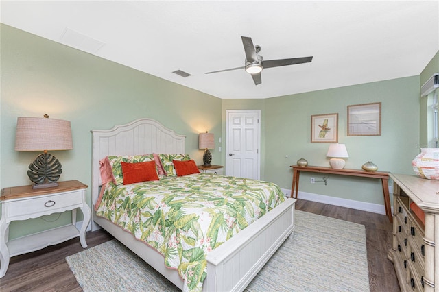 bedroom with dark hardwood / wood-style flooring and ceiling fan