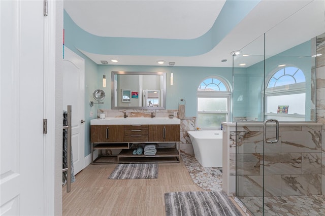 bathroom featuring vanity, separate shower and tub, and tile walls