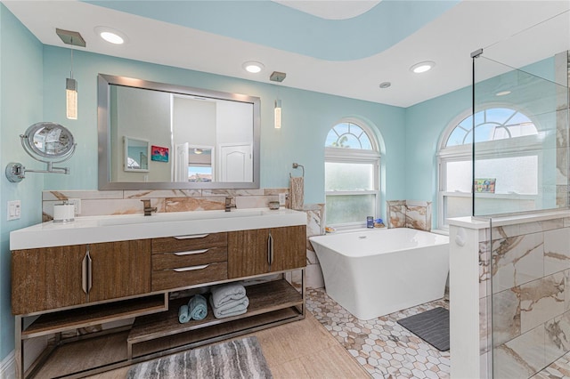 bathroom with vanity and separate shower and tub