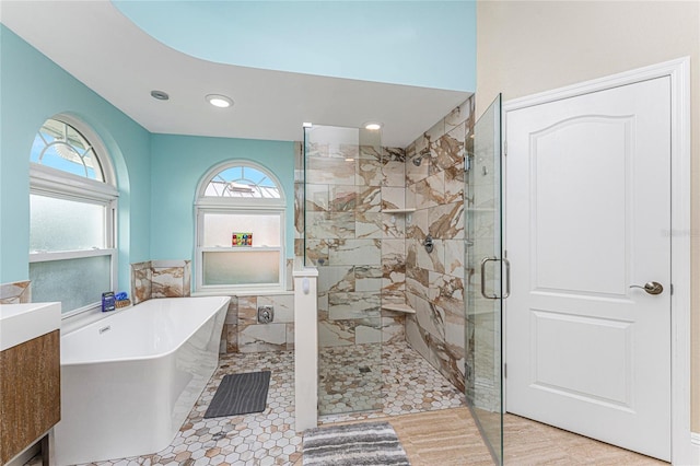 bathroom with tile patterned floors, vanity, and shower with separate bathtub