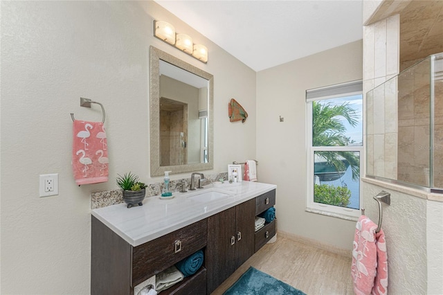 bathroom featuring vanity and tiled shower