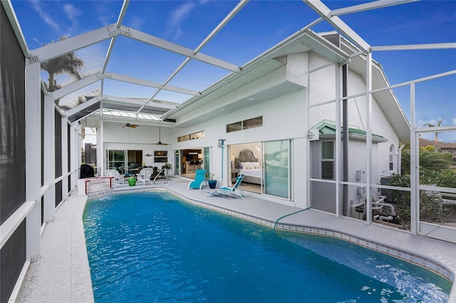 rear view of house with a lanai, a patio, and ceiling fan