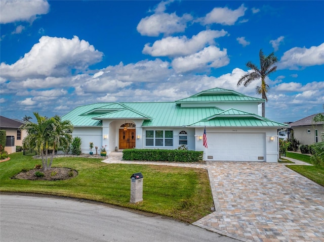 single story home featuring a garage and a front lawn