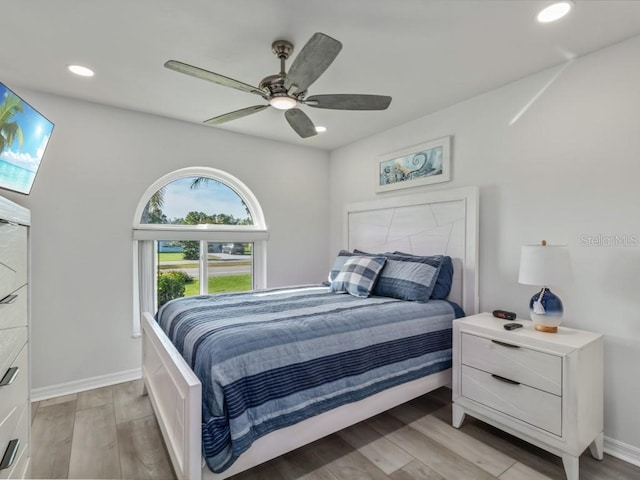 bedroom featuring ceiling fan and light hardwood / wood-style flooring