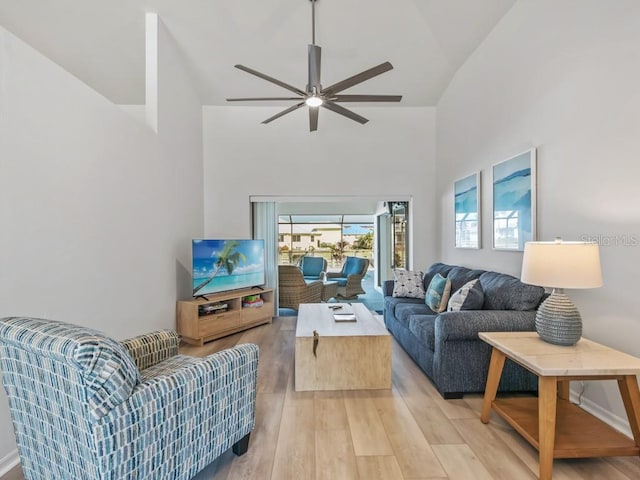 living room featuring ceiling fan, high vaulted ceiling, and hardwood / wood-style floors