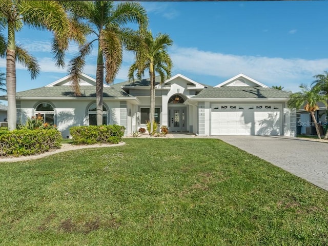 single story home featuring a garage and a front lawn