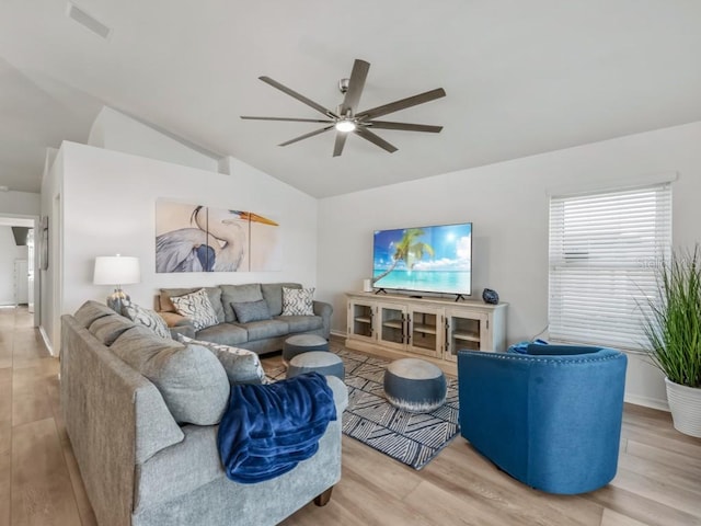 living room with light wood-type flooring, ceiling fan, and lofted ceiling