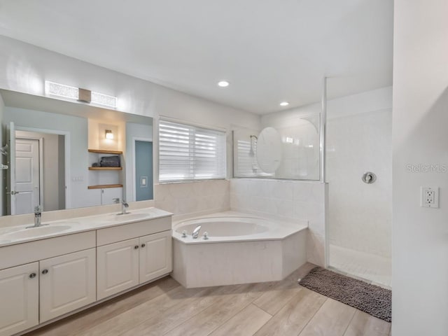 bathroom with vanity and separate shower and tub