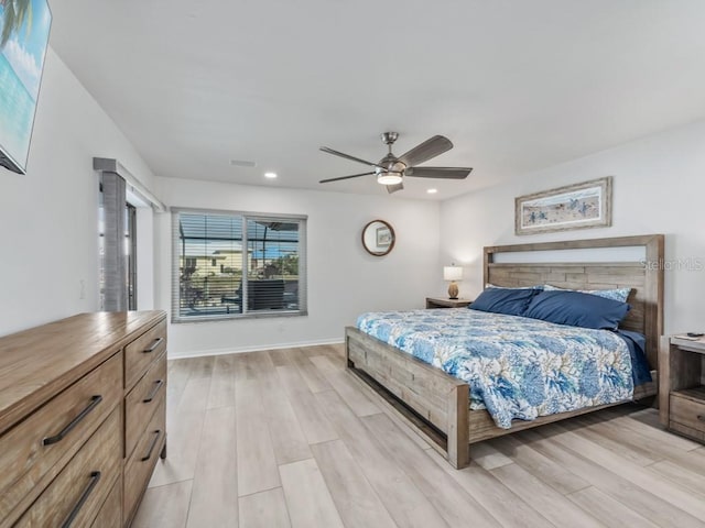 bedroom with light wood-type flooring and ceiling fan