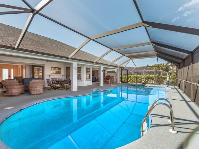 view of swimming pool featuring ceiling fan, a lanai, outdoor lounge area, and a patio