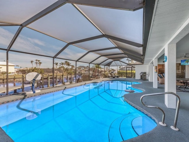 view of swimming pool featuring a patio and a lanai