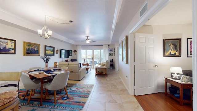 dining area with ceiling fan with notable chandelier