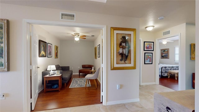 hall with light tile patterned floors