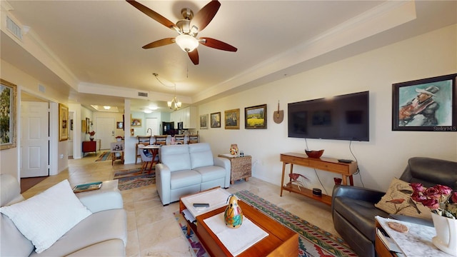 tiled living room featuring ceiling fan with notable chandelier and ornamental molding