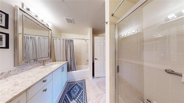 bathroom featuring shower / bath combo, a textured ceiling, and vanity