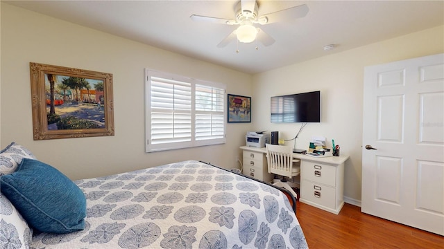 bedroom with ceiling fan and hardwood / wood-style flooring