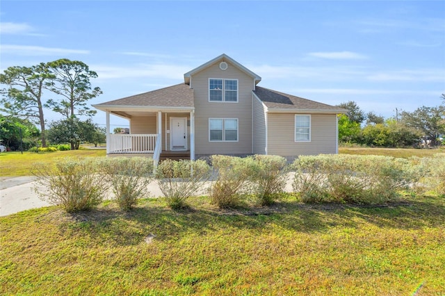 view of front of property with covered porch and a front lawn