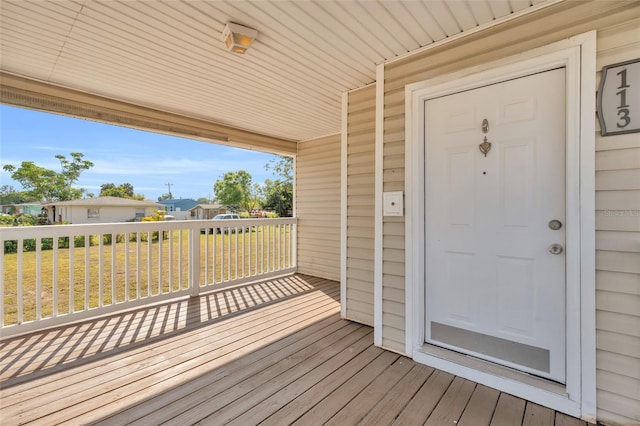 wooden deck featuring a lawn