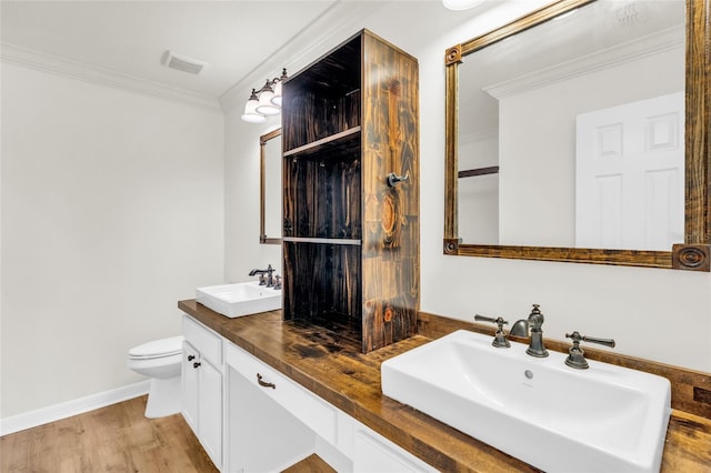 bathroom with ornamental molding, hardwood / wood-style floors, vanity, and toilet