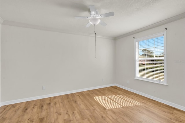 unfurnished room featuring crown molding, ceiling fan, and light hardwood / wood-style flooring