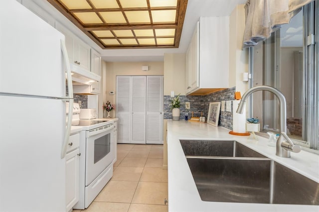 kitchen featuring sink, white cabinetry, light tile patterned floors, white appliances, and decorative backsplash