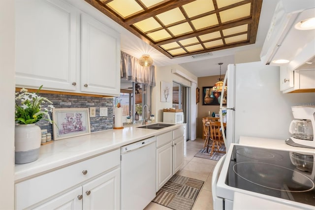 kitchen with decorative light fixtures, sink, white cabinets, light tile patterned floors, and white appliances