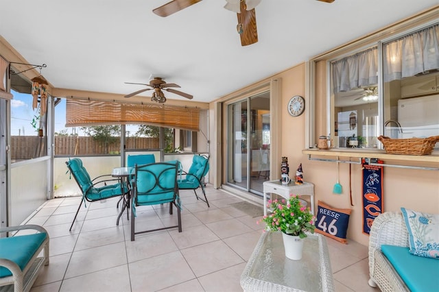 sunroom featuring ceiling fan