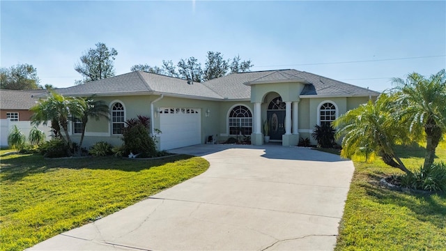 view of front facade with a front yard and a garage