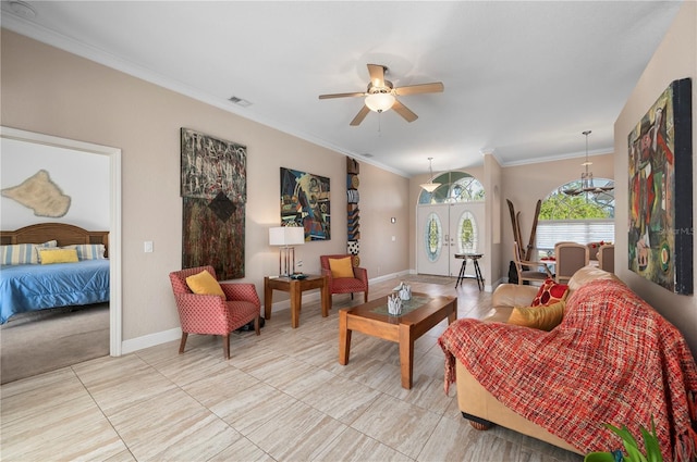 living room with ceiling fan, crown molding, and french doors