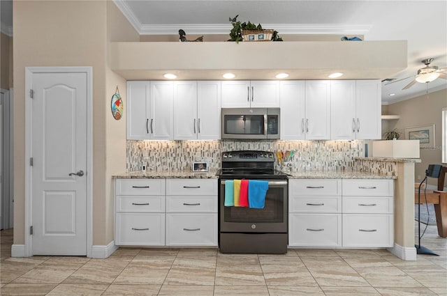 kitchen with backsplash, white cabinetry, range with electric stovetop, and light stone counters