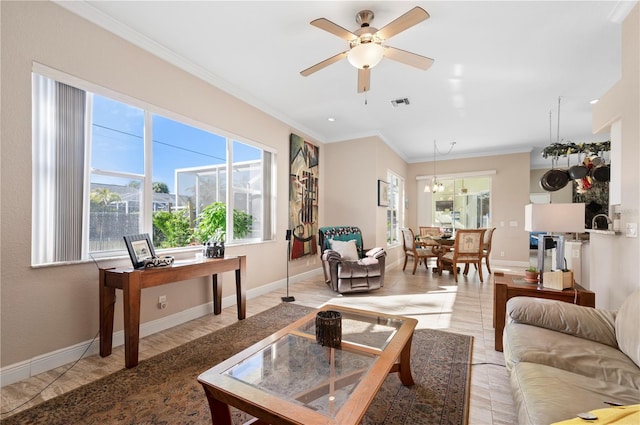 living room featuring ceiling fan with notable chandelier and ornamental molding