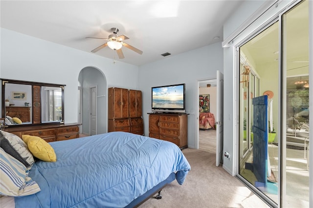 bedroom featuring light carpet, access to exterior, and ceiling fan