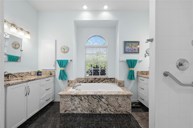 bathroom with vanity and a relaxing tiled tub