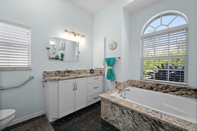 bathroom featuring tiled bath and vanity