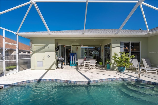 back of house with glass enclosure and a patio area