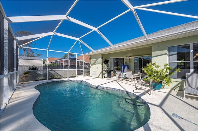 view of pool featuring a lanai, a patio, and ceiling fan