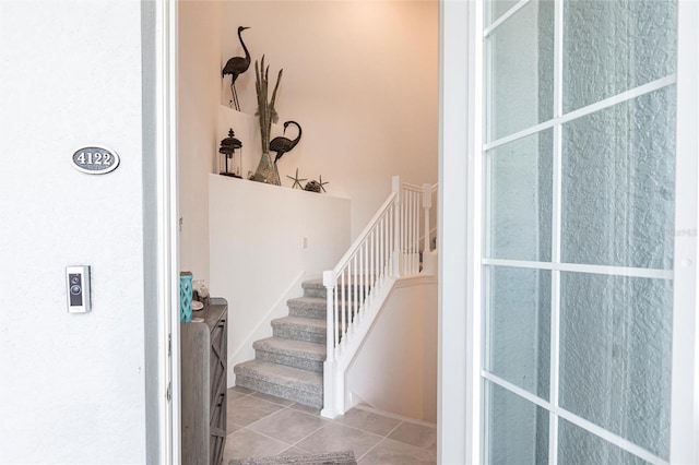 staircase with tile patterned floors