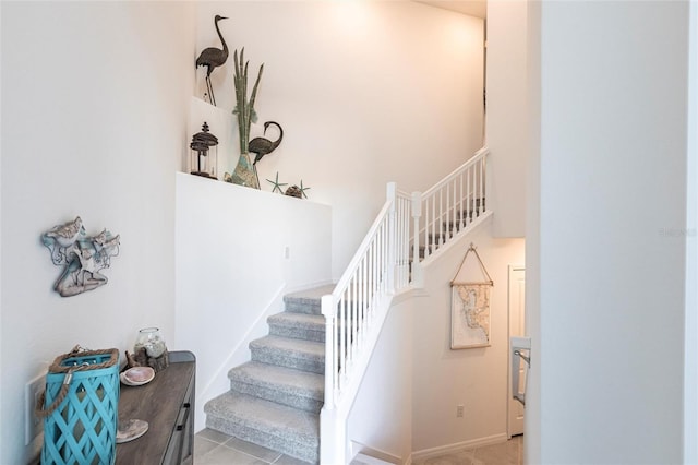 staircase with a towering ceiling