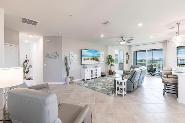 living room featuring light tile patterned floors and ceiling fan