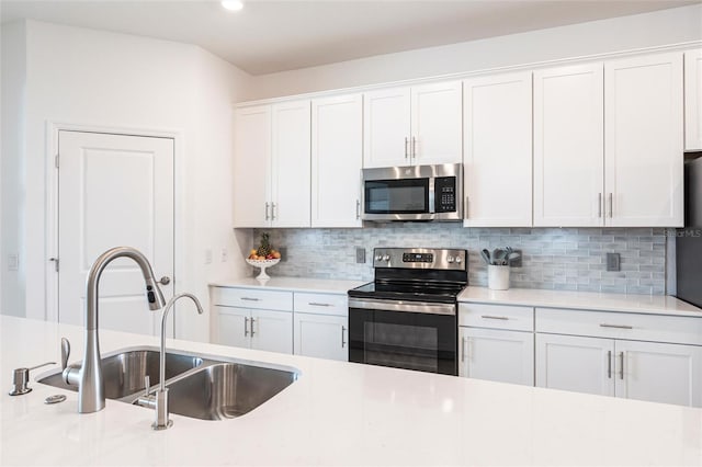 kitchen featuring stainless steel appliances and white cabinets