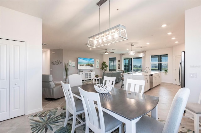 tiled dining area featuring sink and ceiling fan