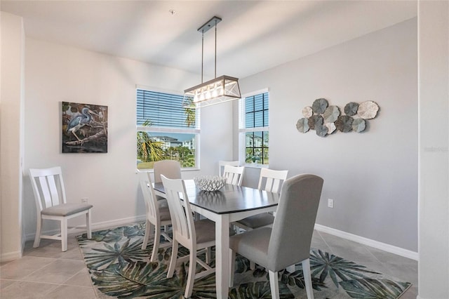 tiled dining area with a chandelier